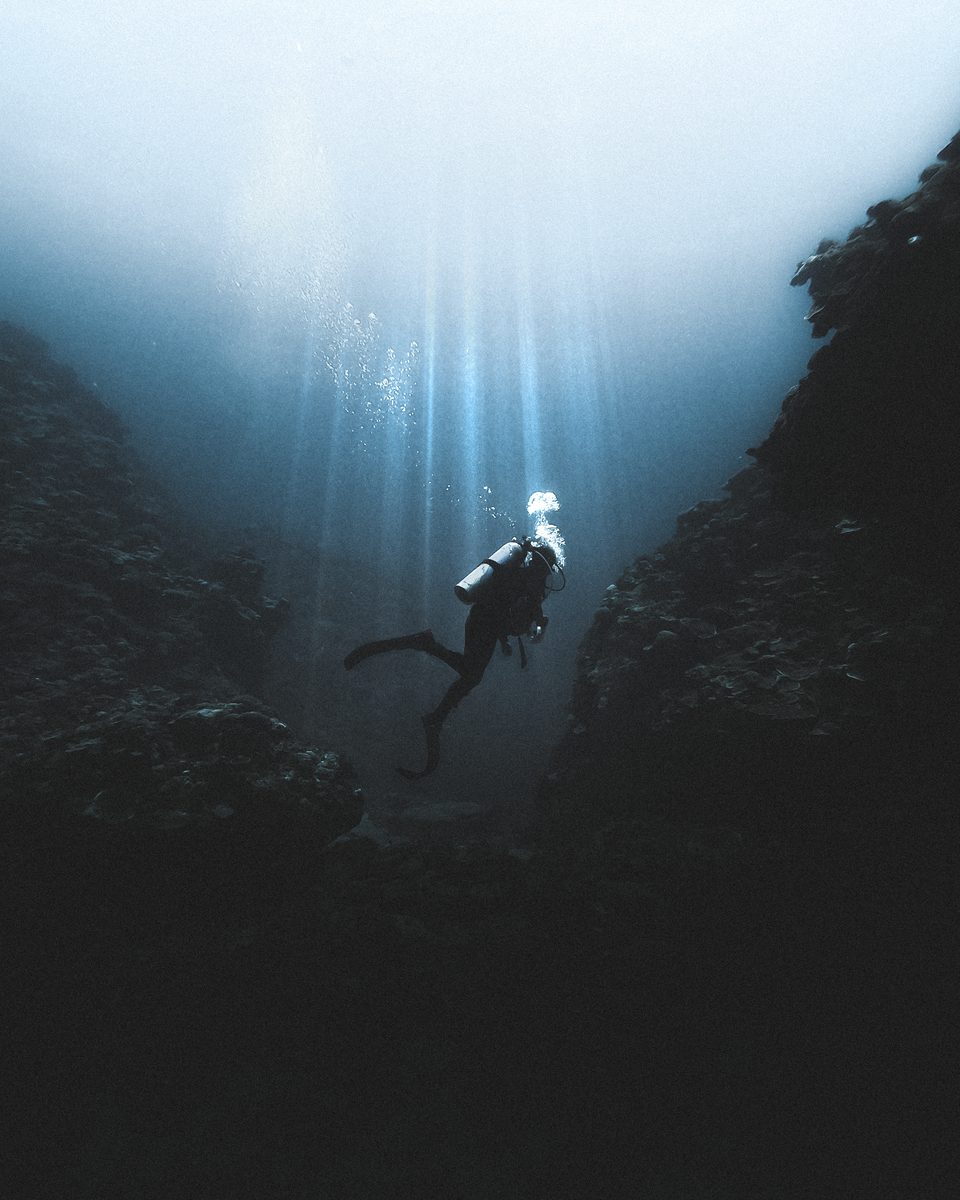 Diver descending into deep water